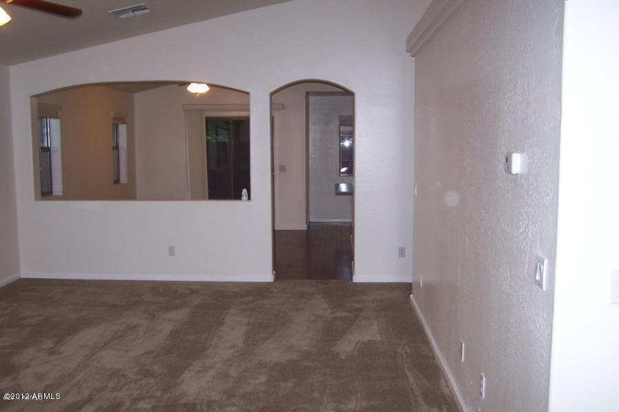 8634 West Riley Road Tolleson, AZ 85353 - Photo 6 of 12 an empty room with mirror