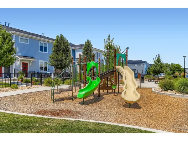 a childrens park with lots of swings and slides
