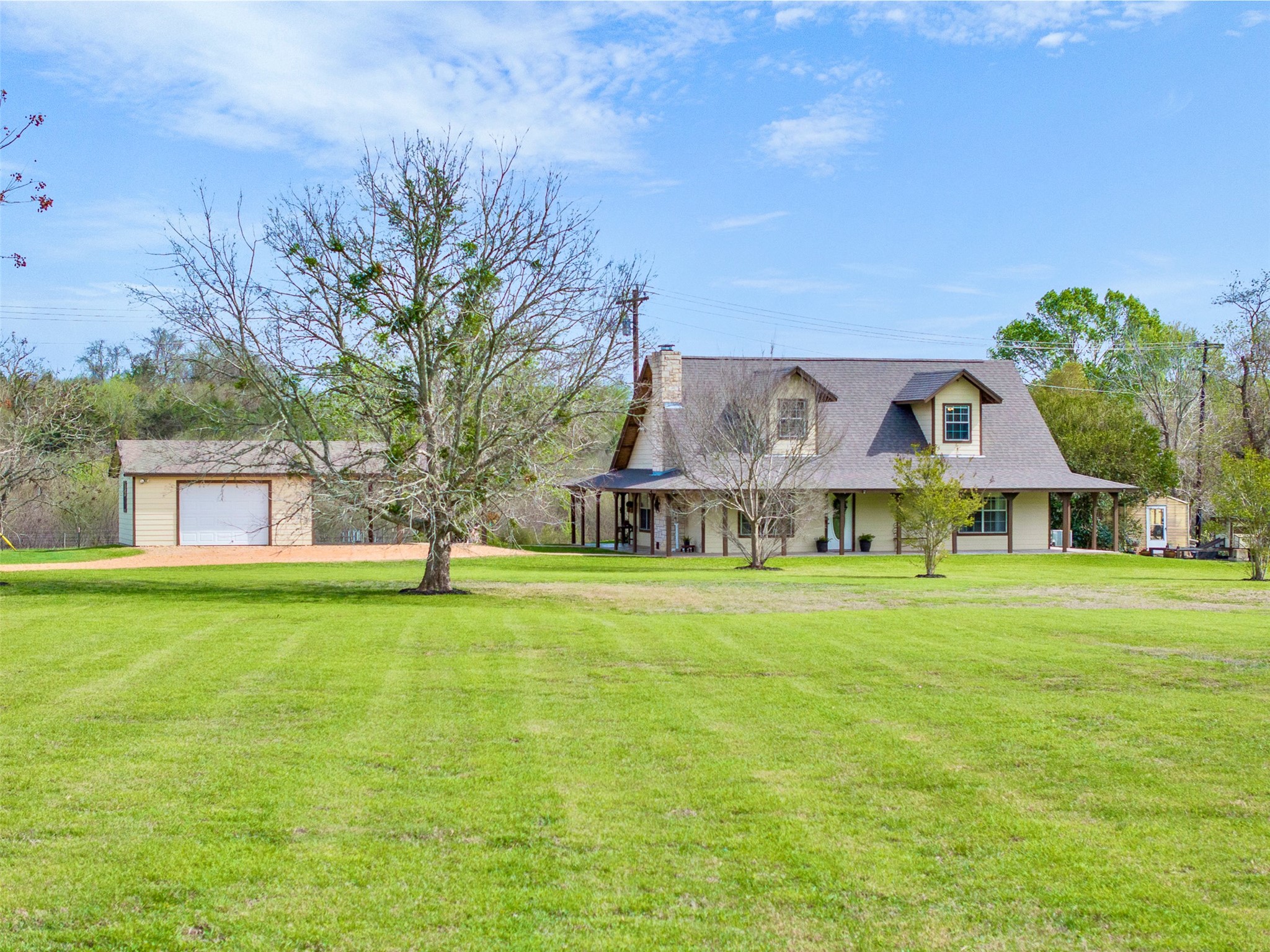 999 Salem Road Brenham, TX 77833 - Photo 4 of 31 a front view of a house with a garden