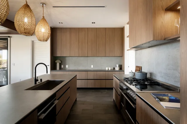 a kitchen with stainless steel appliances a sink a stove and cabinets