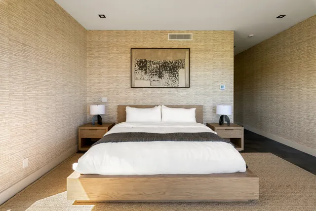 a large white bed in a small room