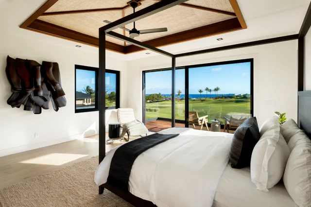 a bedroom with a bed window and lamp