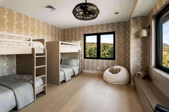 a bedroom with a bed and a large window