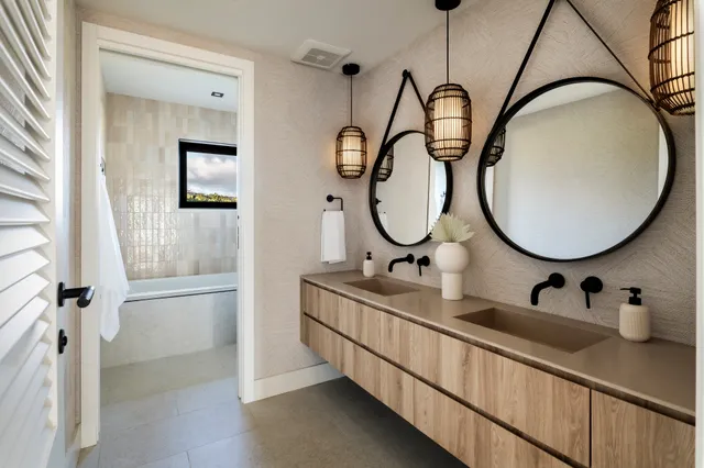 a bathroom with a double vanity sink mirror and tub