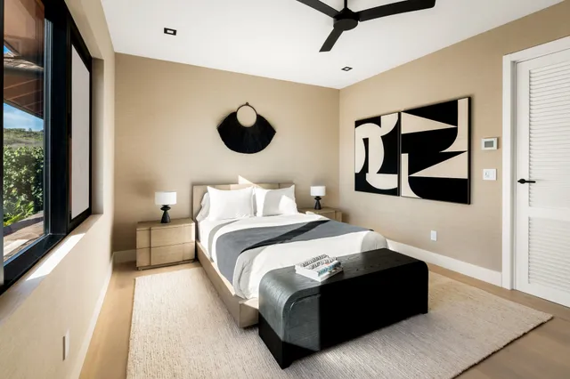 a bedroom with a bed and a painting on the wall