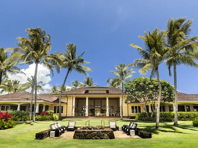 a front view of a residential apartment building with yard