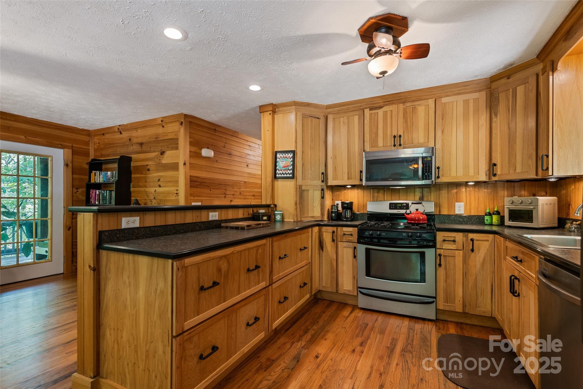 823 Turtle Creek Road Sylva, NC 28779 - Photo 15 of 38 a kitchen with stainless steel appliances a stove sink and microwave