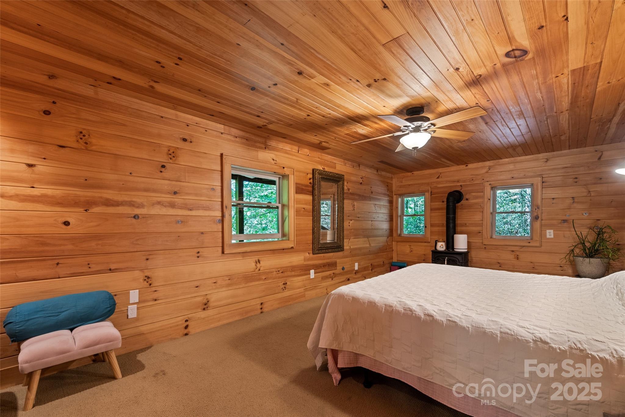 823 Turtle Creek Road Sylva, NC 28779 - Photo 18 of 38 a bedroom with a bed and wooden floor
