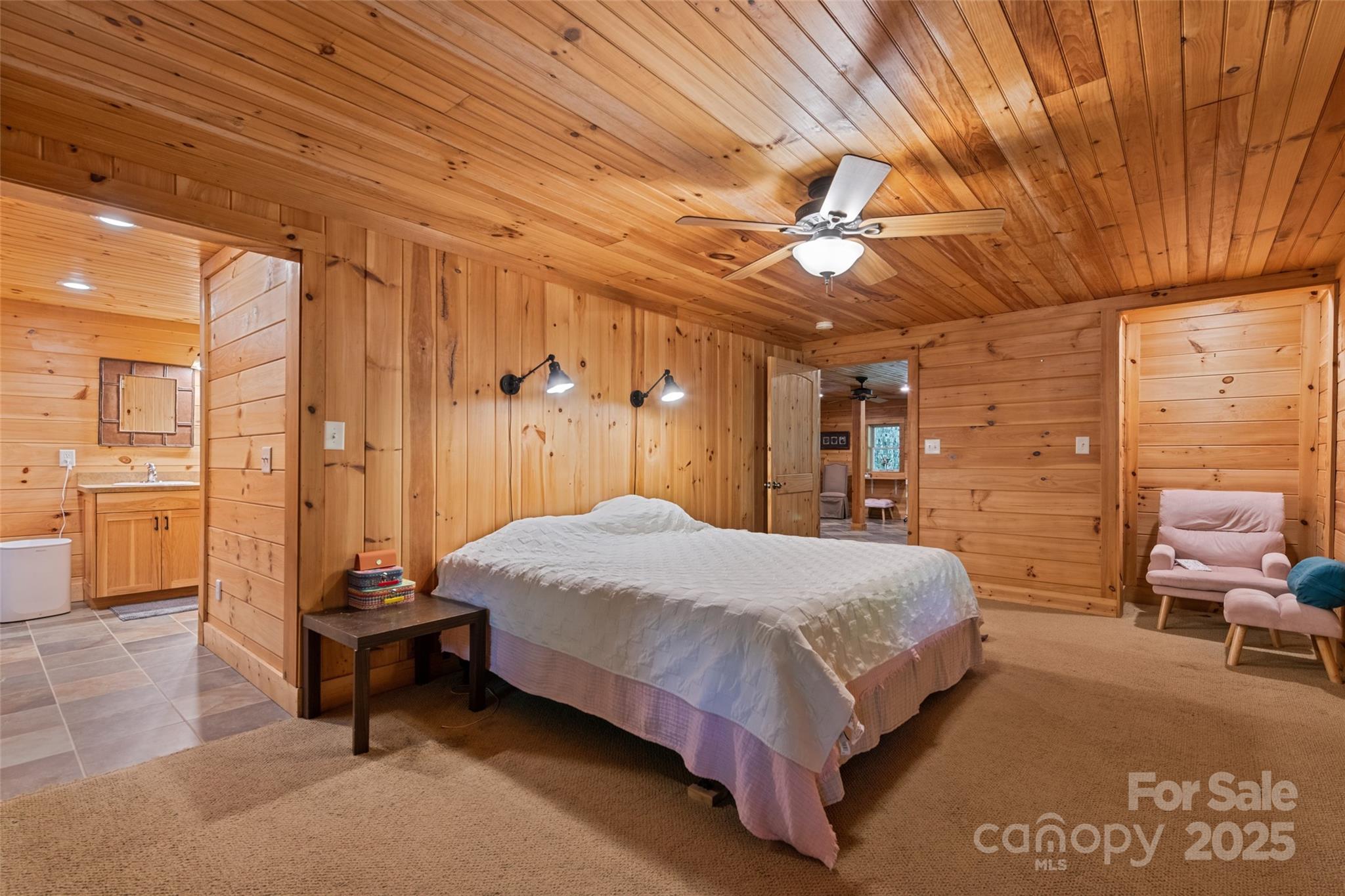 823 Turtle Creek Road Sylva, NC 28779 - Photo 19 of 38 a spacious bedroom with a bed and a chandelier