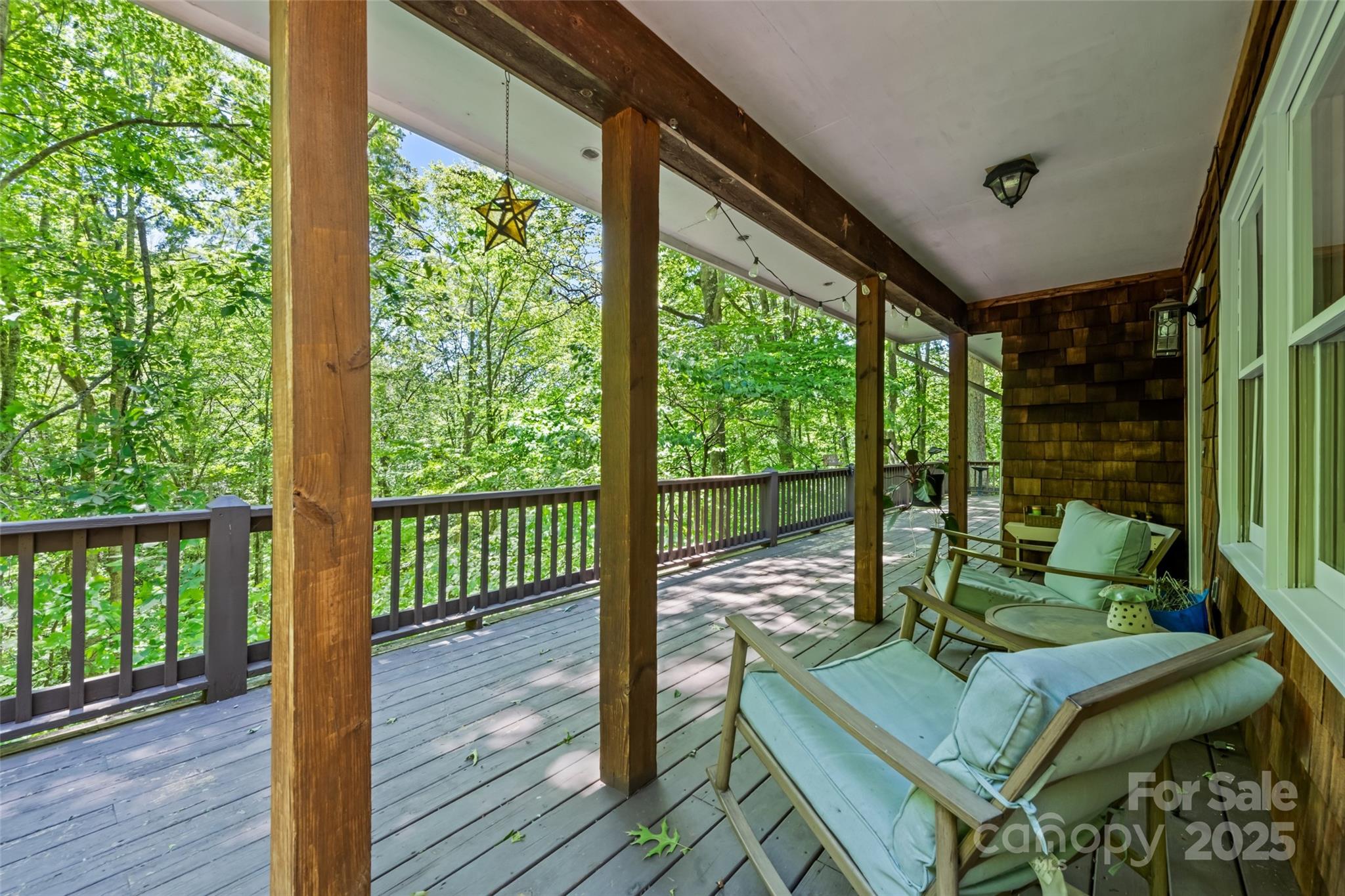 823 Turtle Creek Road Sylva, NC 28779 - Photo 3 of 38 a living room with a floor to ceiling window and wooden floor