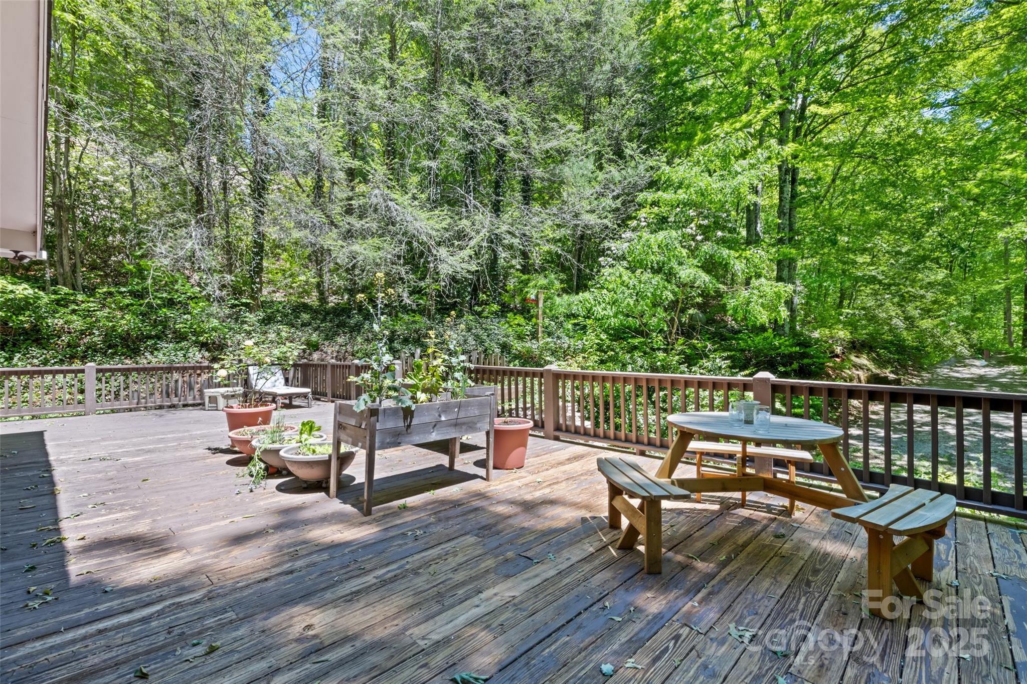 823 Turtle Creek Road Sylva, NC 28779 - Photo 5 of 38 a view of a deck with chairs a barbeque with wooden floor and fence