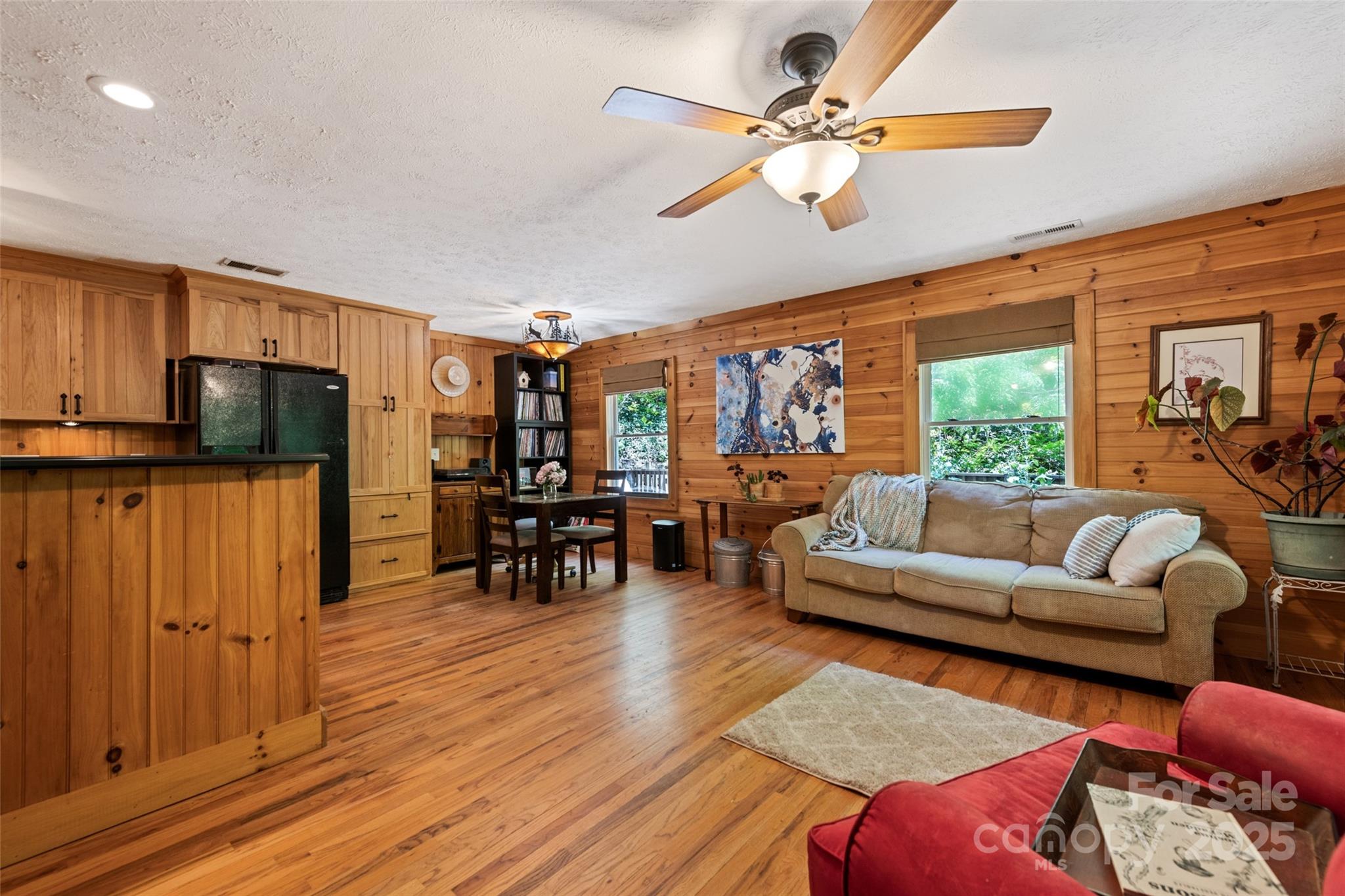 823 Turtle Creek Road Sylva, NC 28779 - Photo 9 of 38 a living room with furniture and a flat screen tv with wooden floor