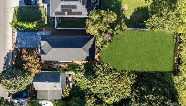 an aerial view of a house with a yard and garden