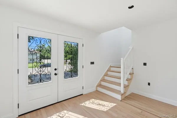 a view of entryway with wooden floor and window