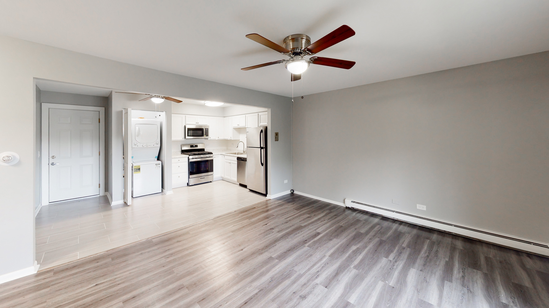 101 Sunset Drive, Unit 2E4 Cary, IL 60013 - Photo 3 of 8 wooden floor in an empty room with a window