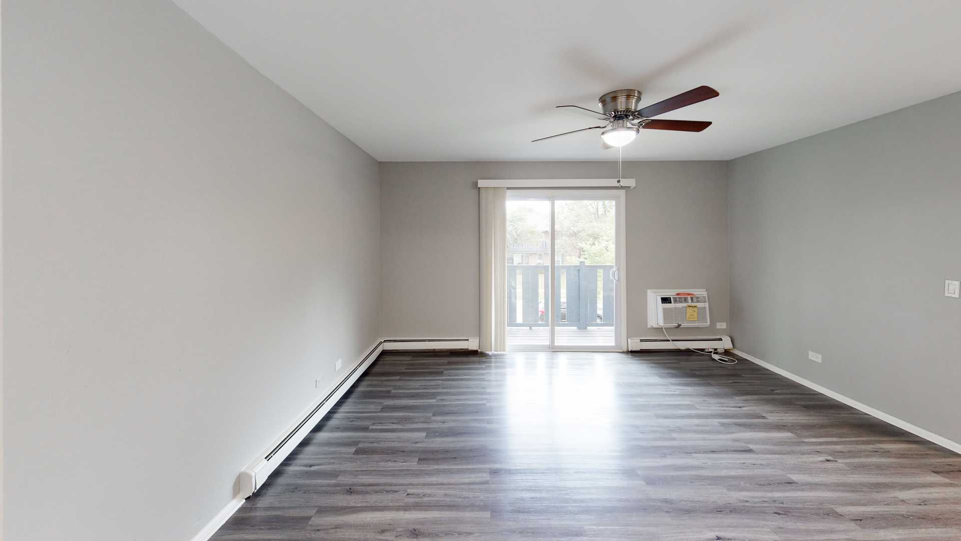 101 Sunset Drive, Unit 2E4 Cary, IL 60013 - Photo 4 of 8 a view of an empty room with window and wooden floor