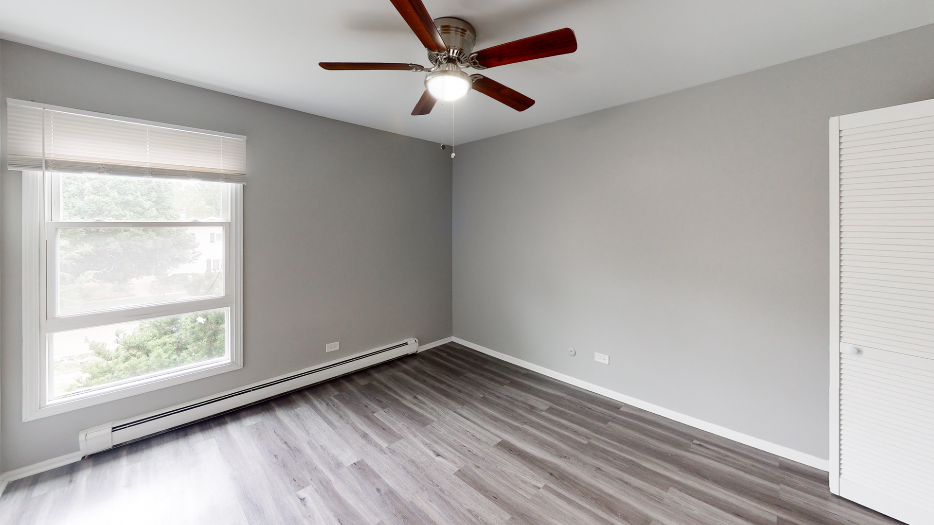 101 Sunset Drive, Unit 2E4 Cary, IL 60013 - Photo 6 of 8 an empty room with a window and a fan