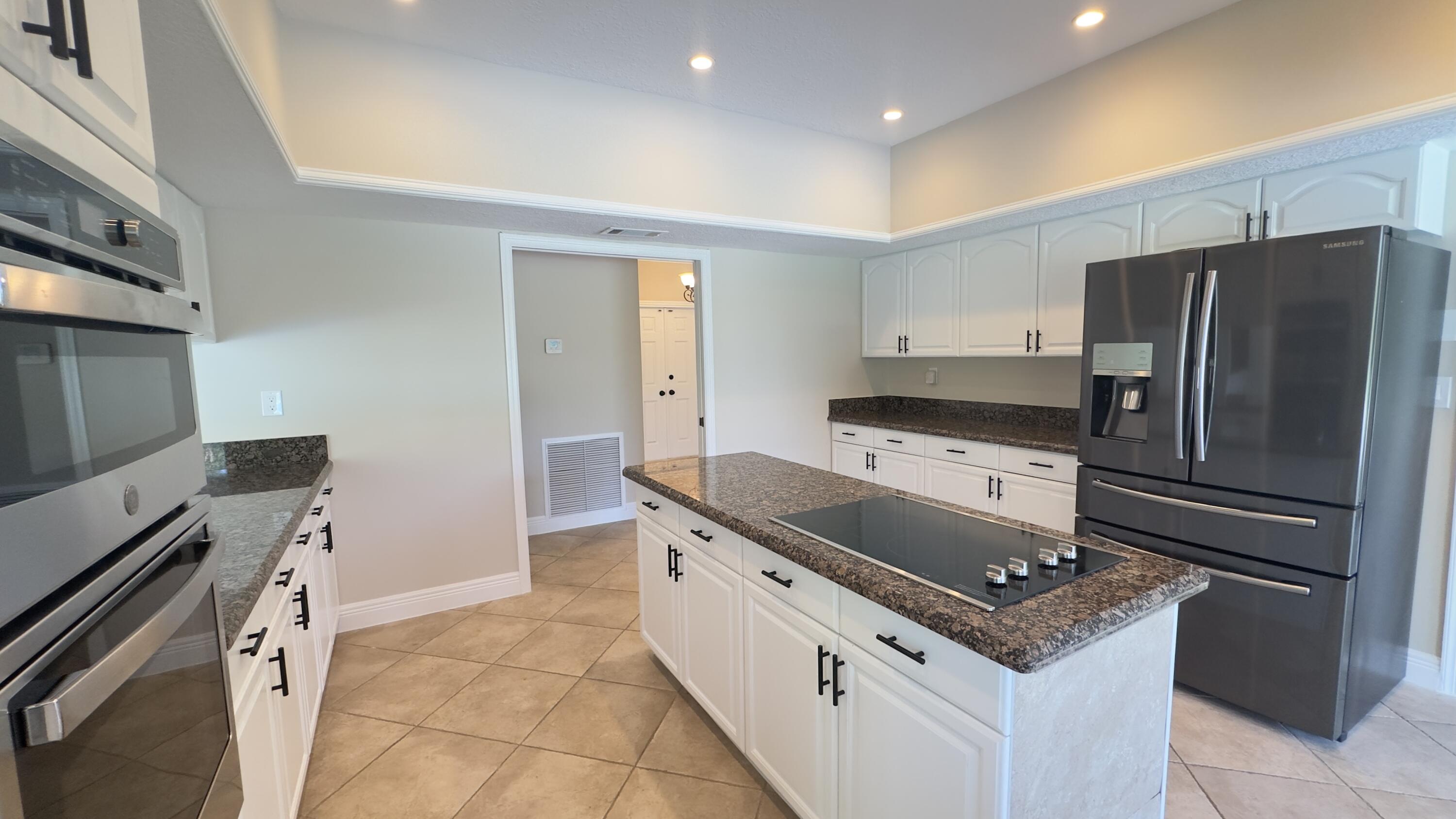 11330 Timber Lodge Terrace Boca Raton, FL 33428 - Photo 6 of 23 a kitchen with a stove sink and refrigerator