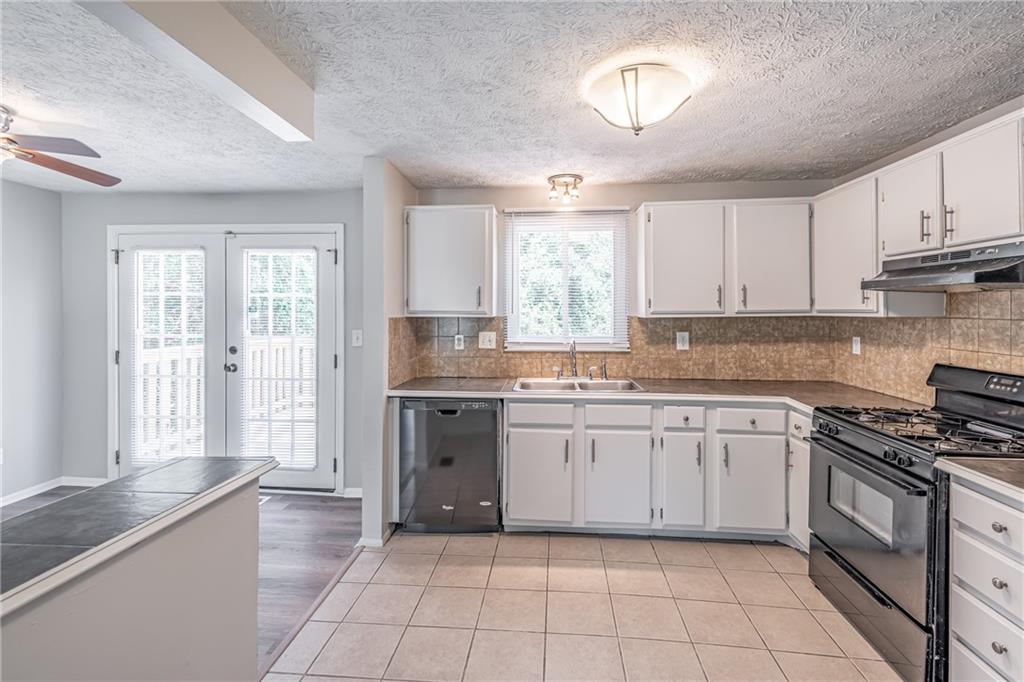 2407 Redfield Drive Norcross, GA 30071 - Photo 20 of 37 a kitchen with a stove a sink and a refrigerator