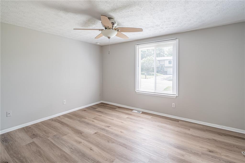 2407 Redfield Drive Norcross, GA 30071 - Photo 21 of 37 wooden floor in an empty room with a window