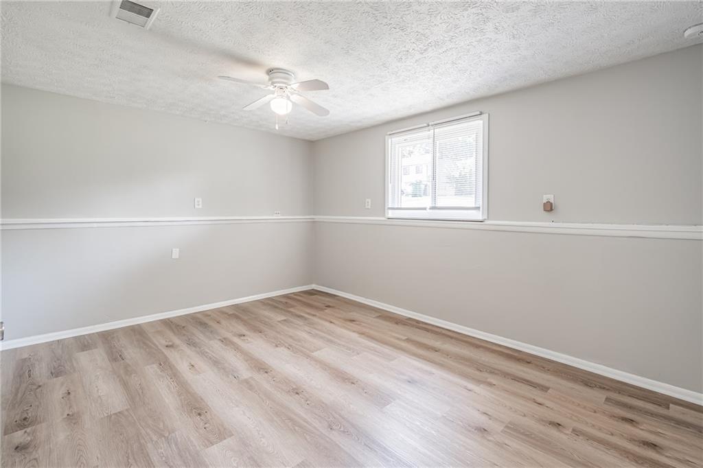 2407 Redfield Drive Norcross, GA 30071 - Photo 25 of 37 wooden floor in an empty room with a window