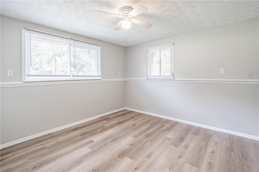 2407 Redfield Drive Norcross, GA 30071 - Photo 28 of 37 wooden floor in an empty room with a window
