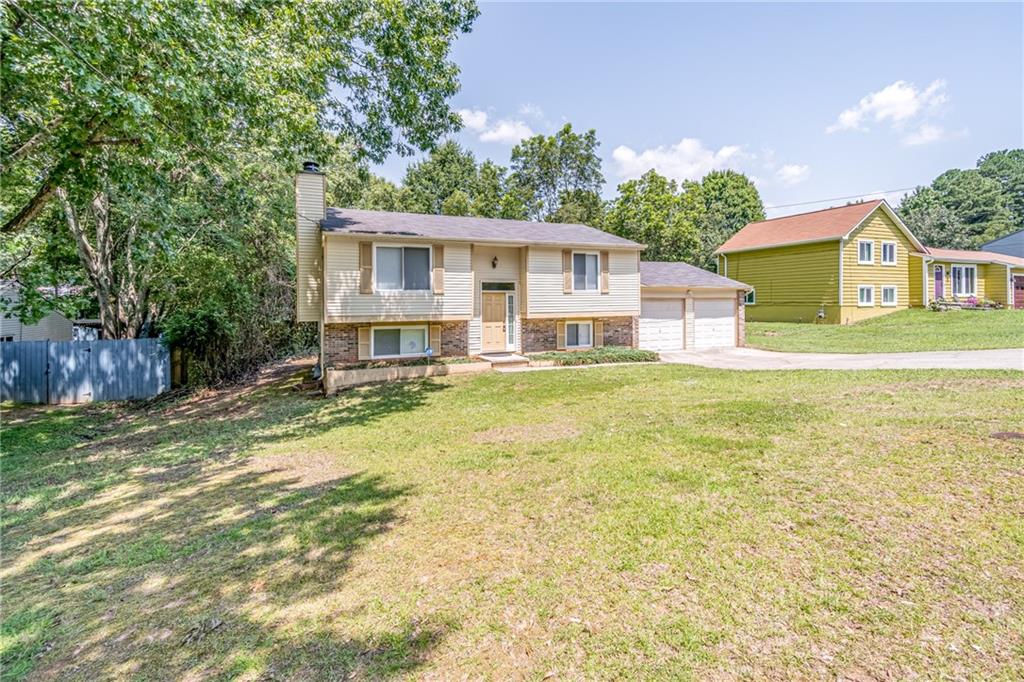 2407 Redfield Drive Norcross, GA 30071 - Photo 3 of 37 a front view of a house with a yard and trees
