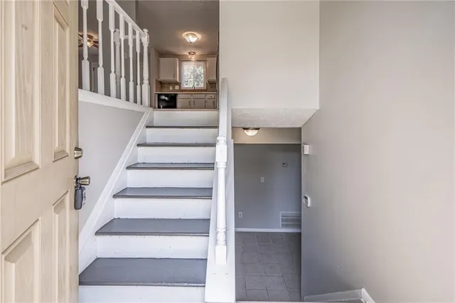 a view of staircase with white walls and windows