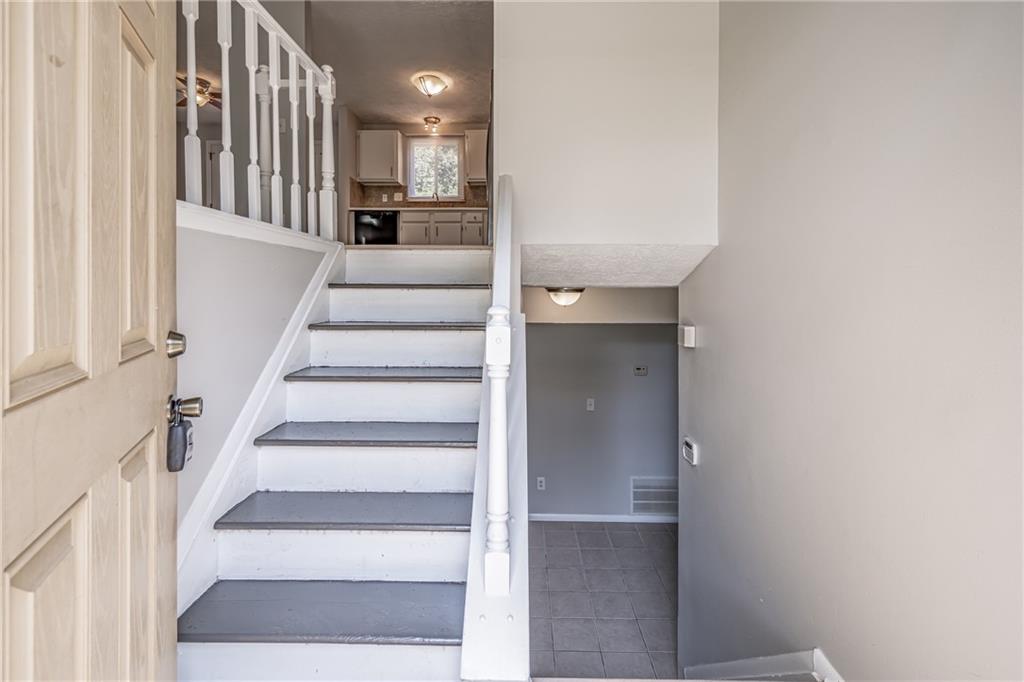 2407 Redfield Drive Norcross, GA 30071 - Photo 7 of 37 a view of staircase with white walls and windows
