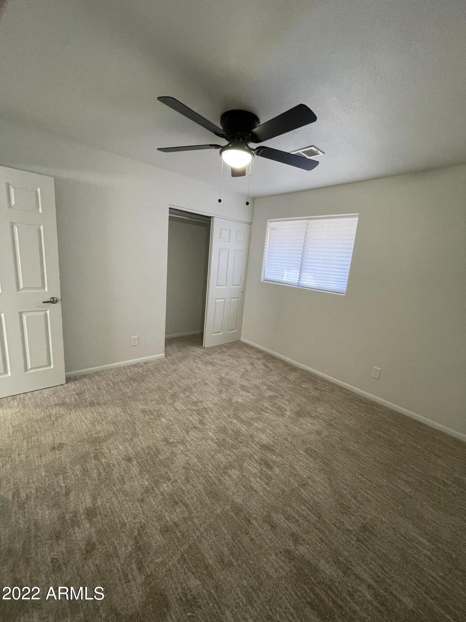 5207 West Osborn Road Phoenix, AZ 85031 - Photo 33 of 35 an empty room with windows and fan