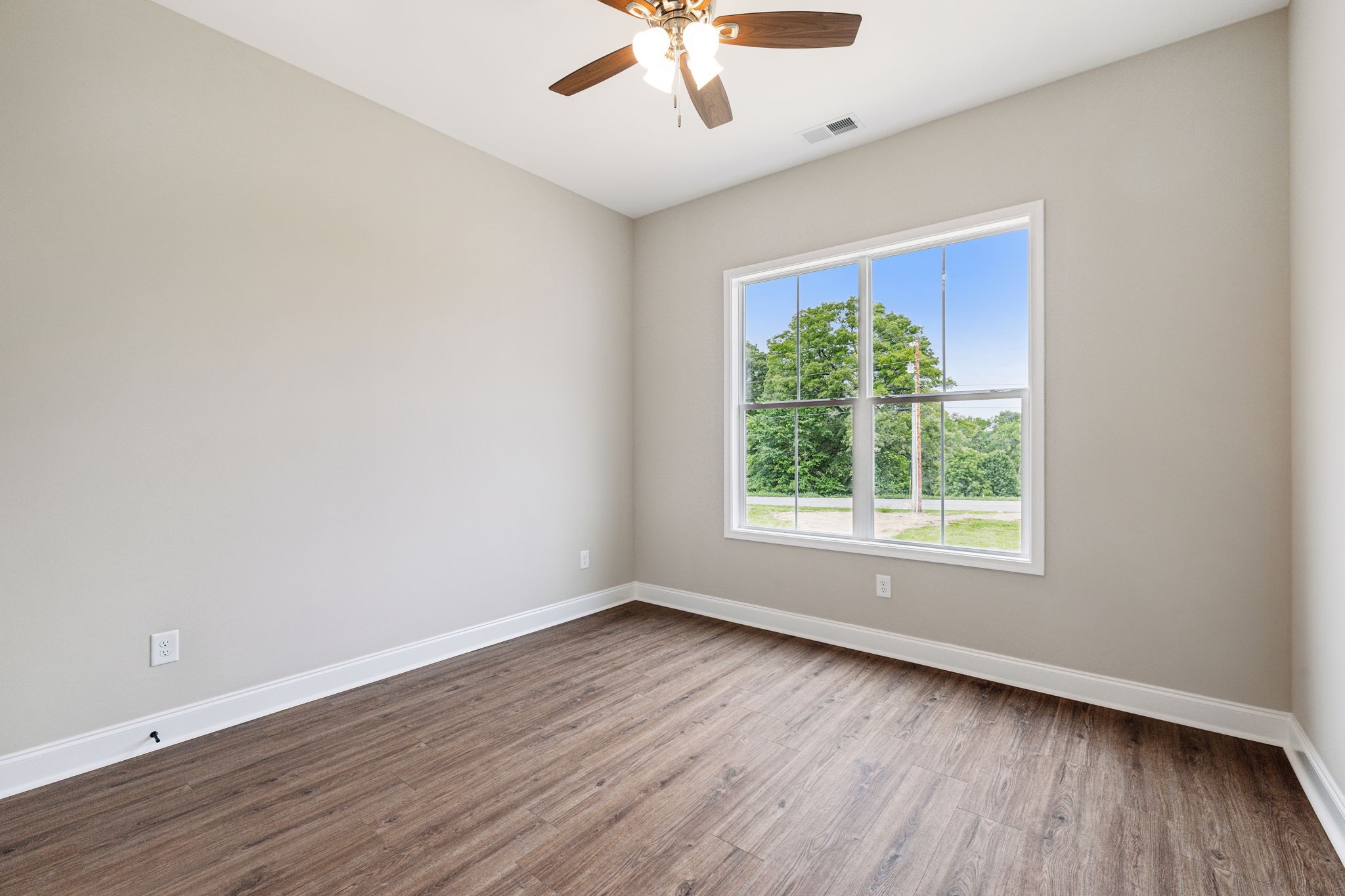 5751 Youngville Road Springfield, TN 37172 - Photo 20 of 45 an empty room with wooden floor chandelier fan and windows