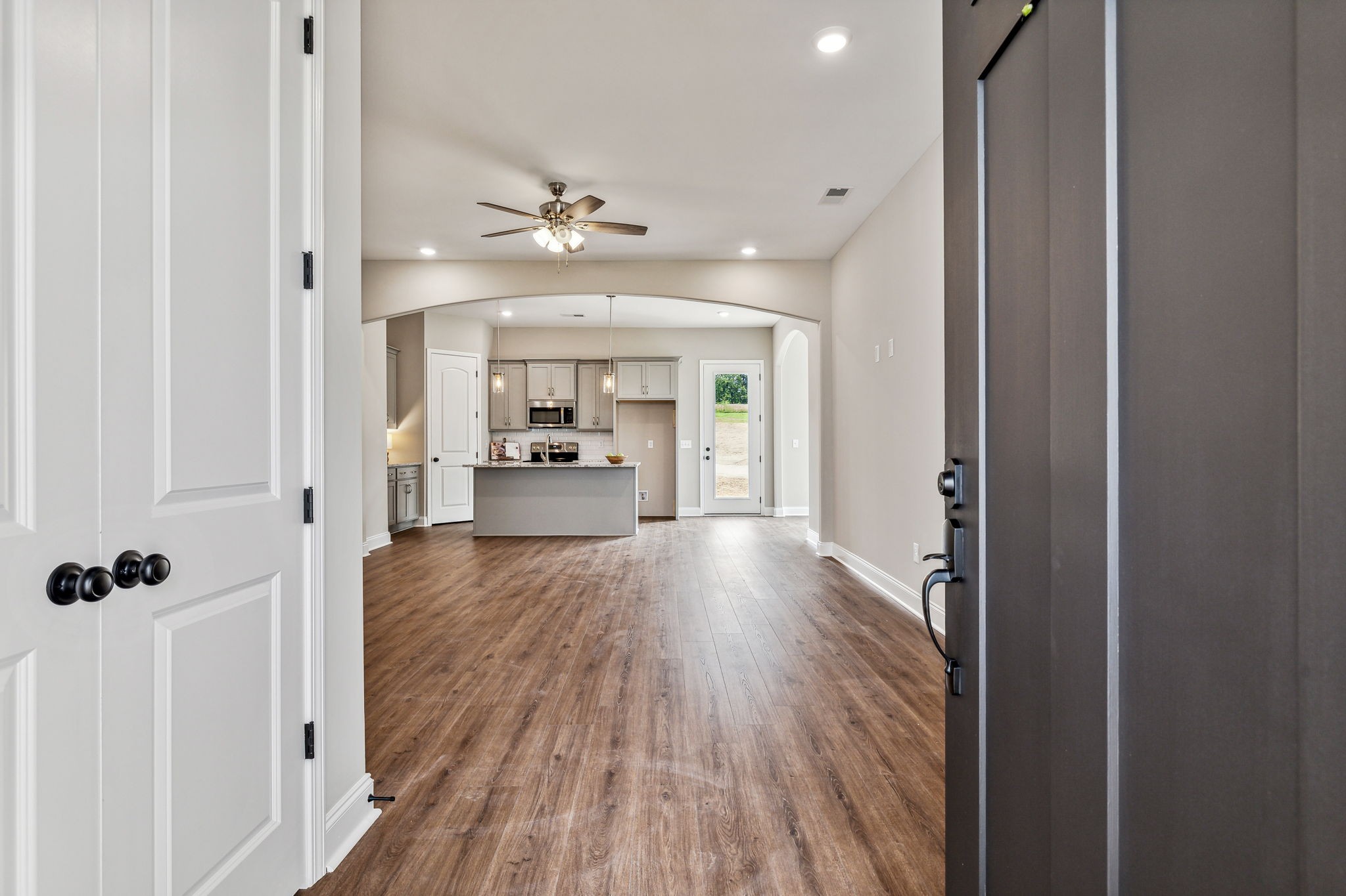 5751 Youngville Road Springfield, TN 37172 - Photo 4 of 45 a view of a hallway with wooden floor and a kitchen
