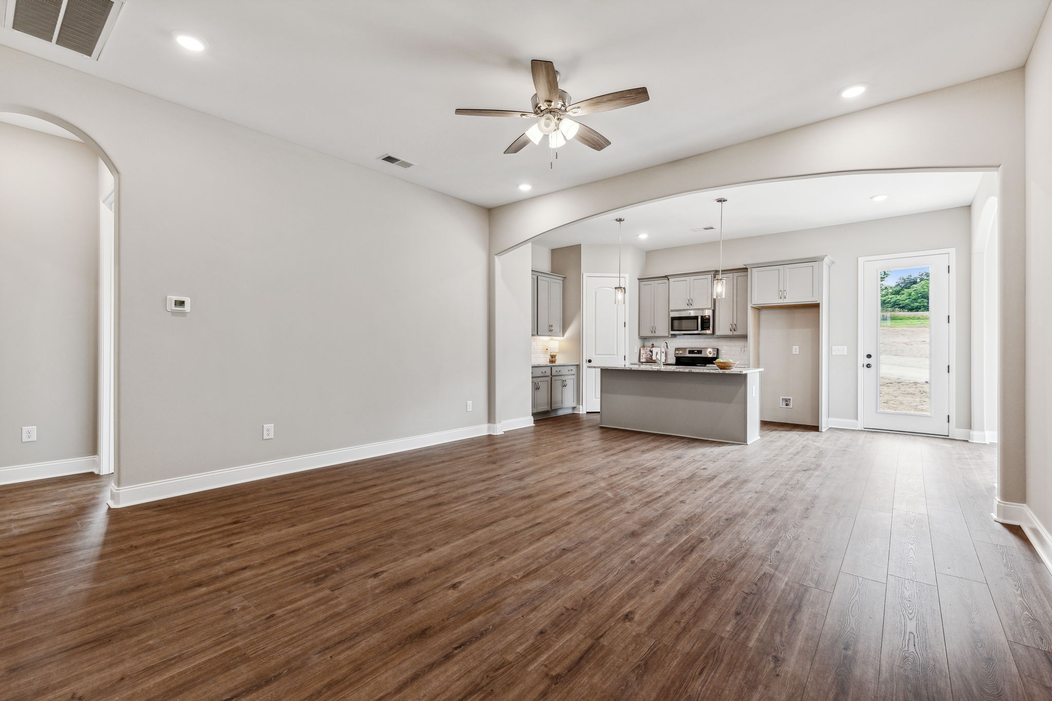 5751 Youngville Road Springfield, TN 37172 - Photo 5 of 45 a view of an empty room and kitchen with wooden floor