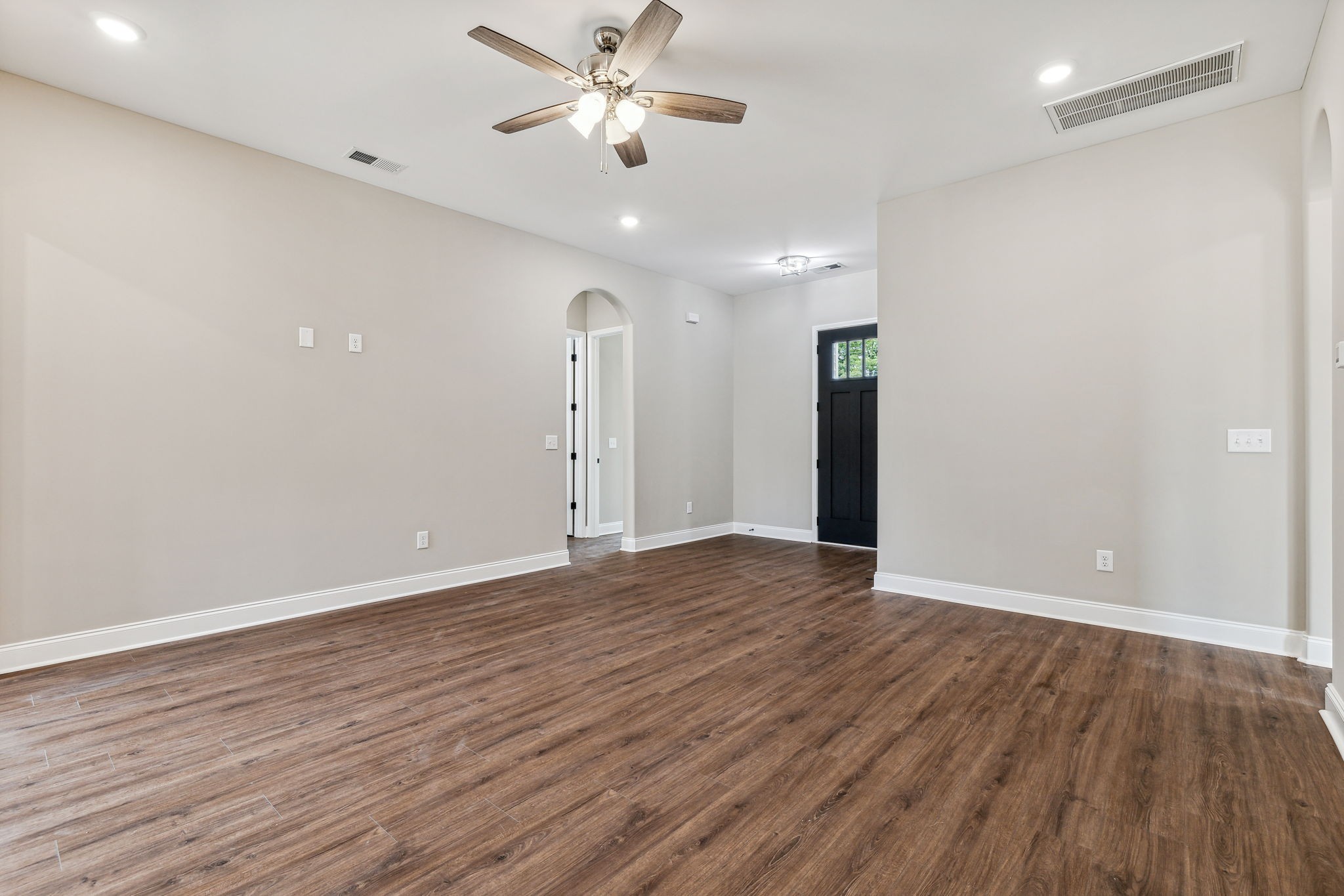 5751 Youngville Road Springfield, TN 37172 - Photo 7 of 45 an empty room with wooden floor and ceiling fan