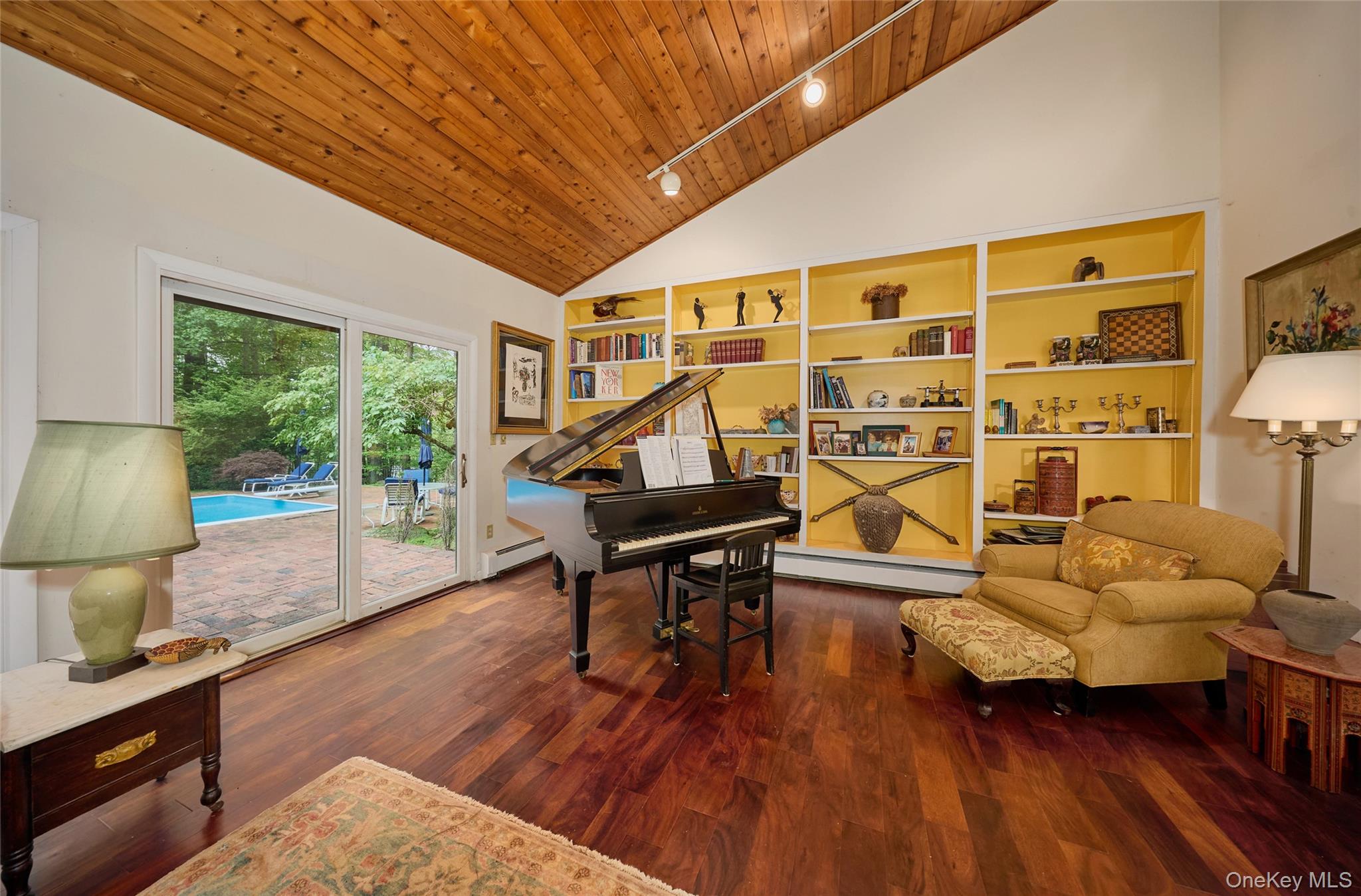 31 Greenlawn Road Katonah, NY 10536 - Photo 14 of 47 Sitting room featuring baseboard heating, wooden ceiling, high vaulted ceiling, built in shelves, and wood finished floors