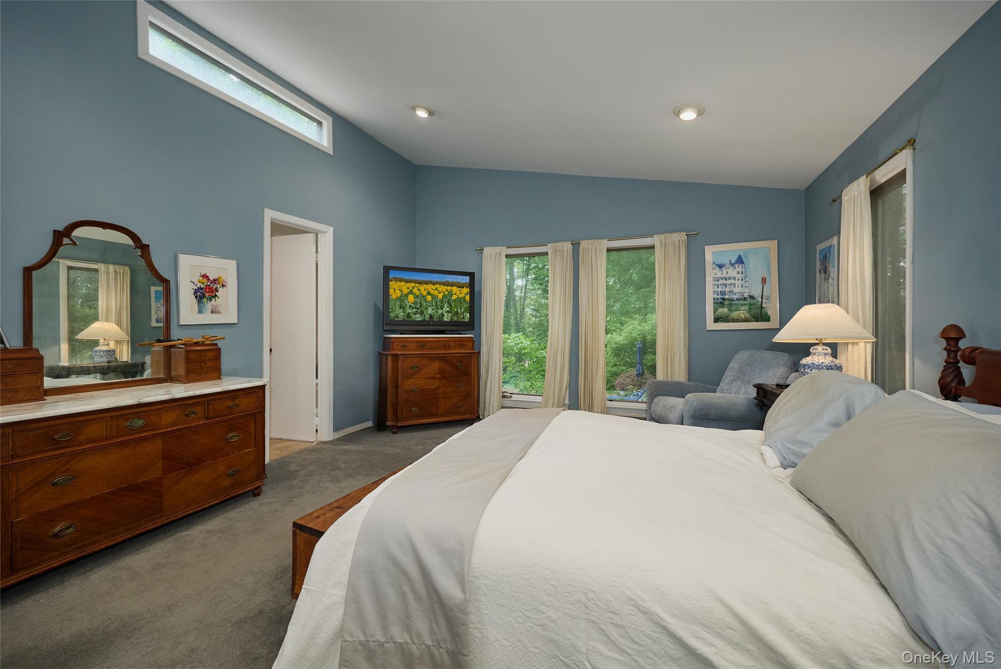 31 Greenlawn Road Katonah, NY 10536 - Photo 18 of 47 Bedroom with dark carpet, multiple windows, and vaulted ceiling