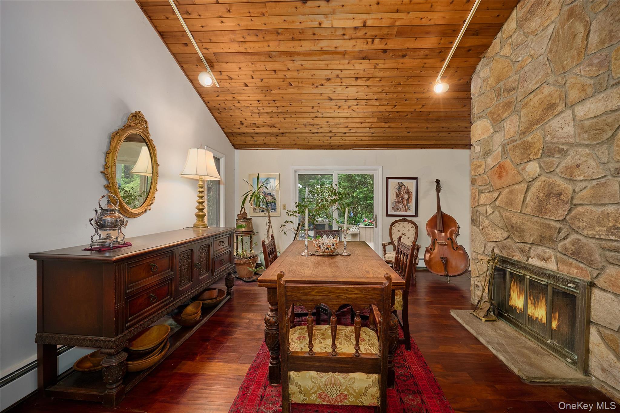31 Greenlawn Road Katonah, NY 10536 - Photo 10 of 47 Dining area featuring wooden ceiling, lofted ceiling, a fireplace, and wood-type flooring