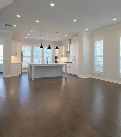 a living room with kitchen island furniture and a wooden floor