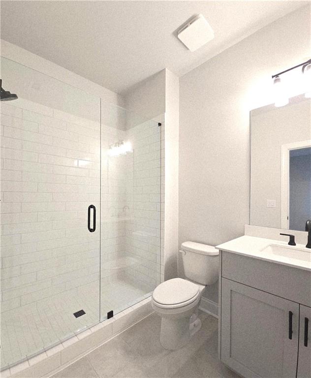 163 Basil Street Cumming, GA 30040 - Photo 28 of 56 a bathroom with a toilet sink and shower