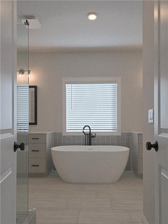 163 Basil Street Cumming, GA 30040 - Photo 34 of 56 a view of a bathtub in a bathroom