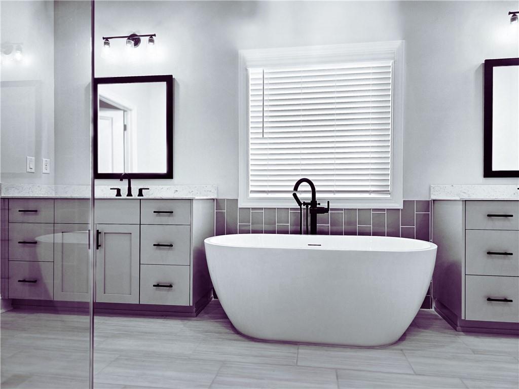 163 Basil Street Cumming, GA 30040 - Photo 35 of 56 a white bath tub sitting in a bathroom