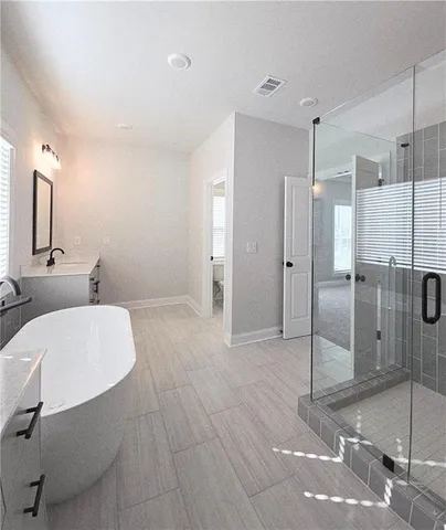 a bathroom with a double vanity sink and a mirror