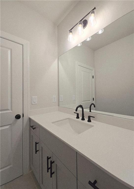 163 Basil Street Cumming, GA 30040 - Photo 42 of 56 a bathroom with a sink and a mirror