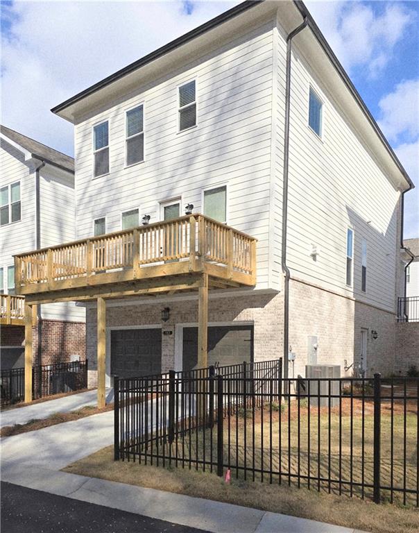 163 Basil Street Cumming, GA 30040 - Photo 47 of 56 a front view of a building with glass windows