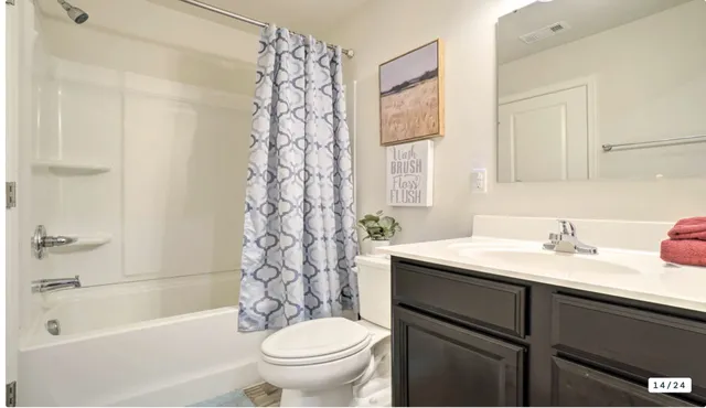 a bathroom with a sink toilet vanity and bathtub