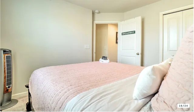 a bedroom with a bed and a mirror