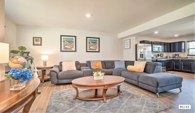 a living room with furniture kitchen and a table