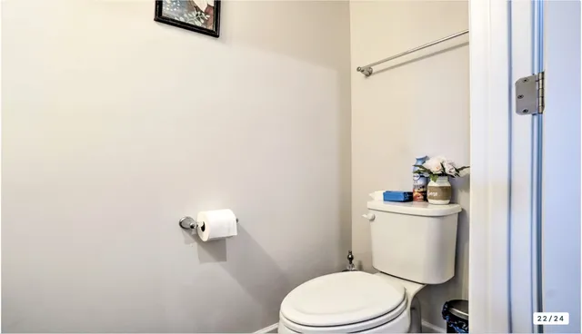 a white toilet sitting next to a bathroom sink