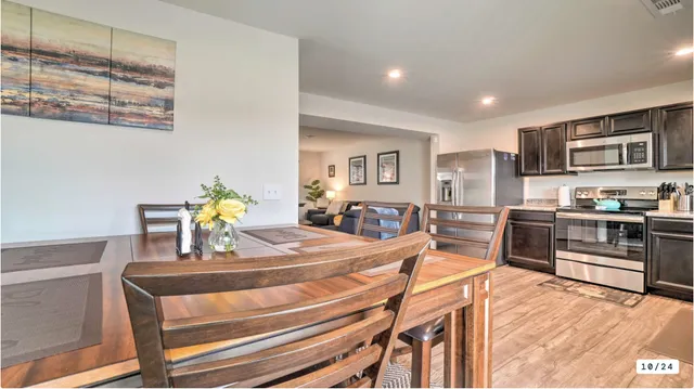 a living room with stainless steel appliances kitchen island granite countertop furniture and a kitchen view