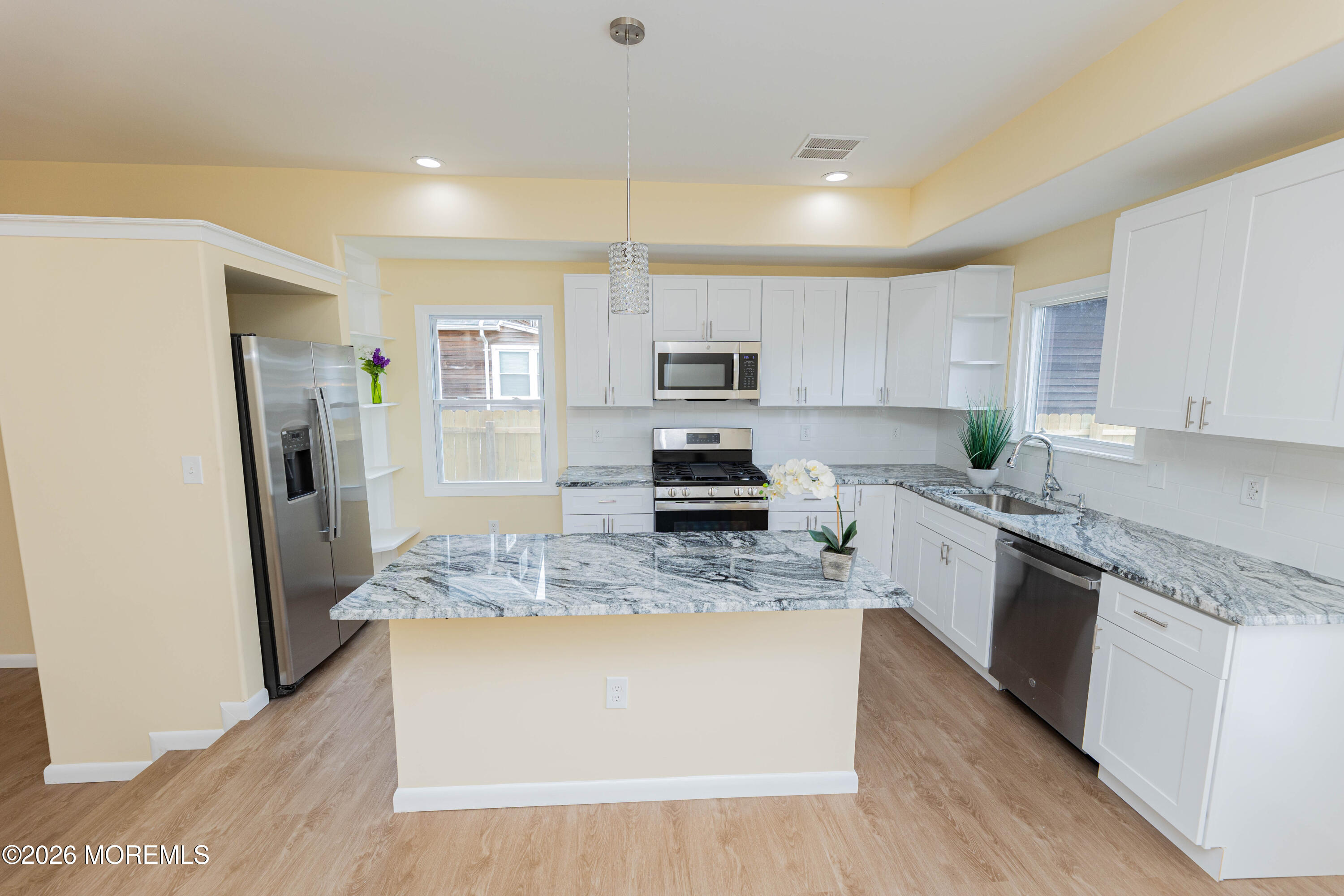 2408 Herbertsville Road Point Pleasant, NJ 08742 - Photo 13 of 82 a large kitchen with stainless steel appliances granite countertop a stove a sink a refrigerator a microwave and white cabinets with wooden floor